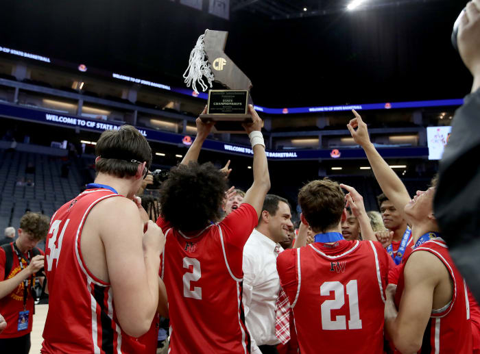 Harvard-Westlake senior Robert Hinton raises the trophy after winning the CIF Open Division state championship on Mar. 9, 2024.